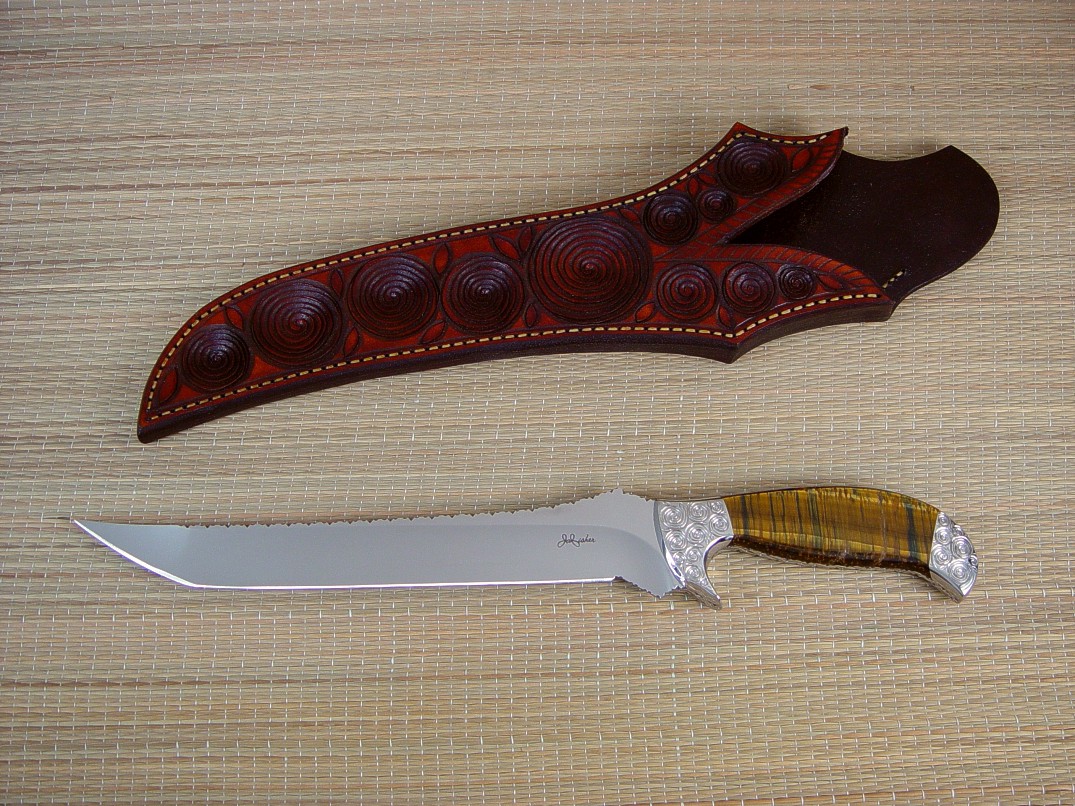 "Deimos" 440C high chromium stainless steel blade, hollow ground, mirror finished, hand-engraved 304 high chromium high nickel stainless steel bolsters, Tiger Eye Quartz gemstone handle, hand-carved and tooled leather sheath