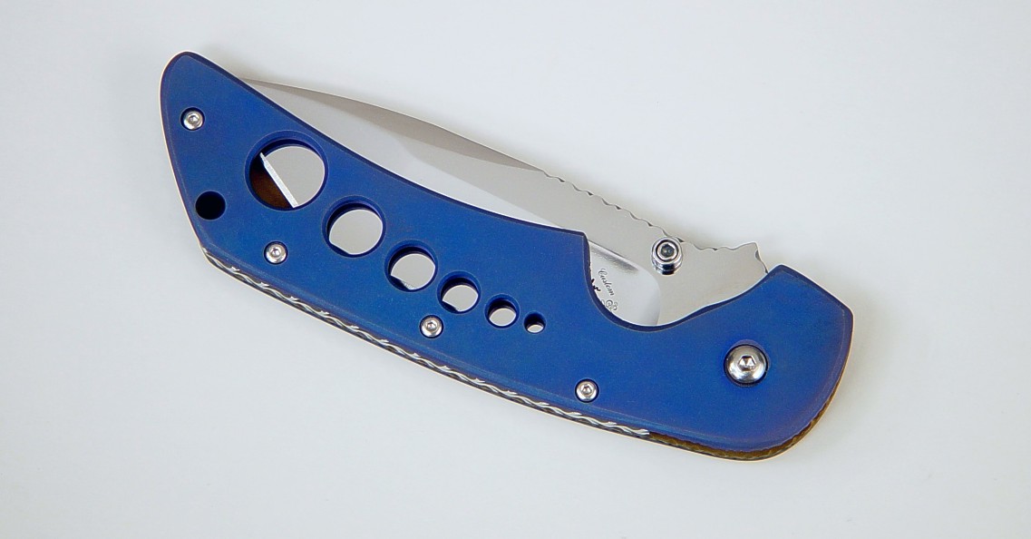 "Stratos" liner lock folding knife, obverse side view: 440C stainless steel blade, anodized 6AL4V titanium liners, leather, nickel plated steel sheath