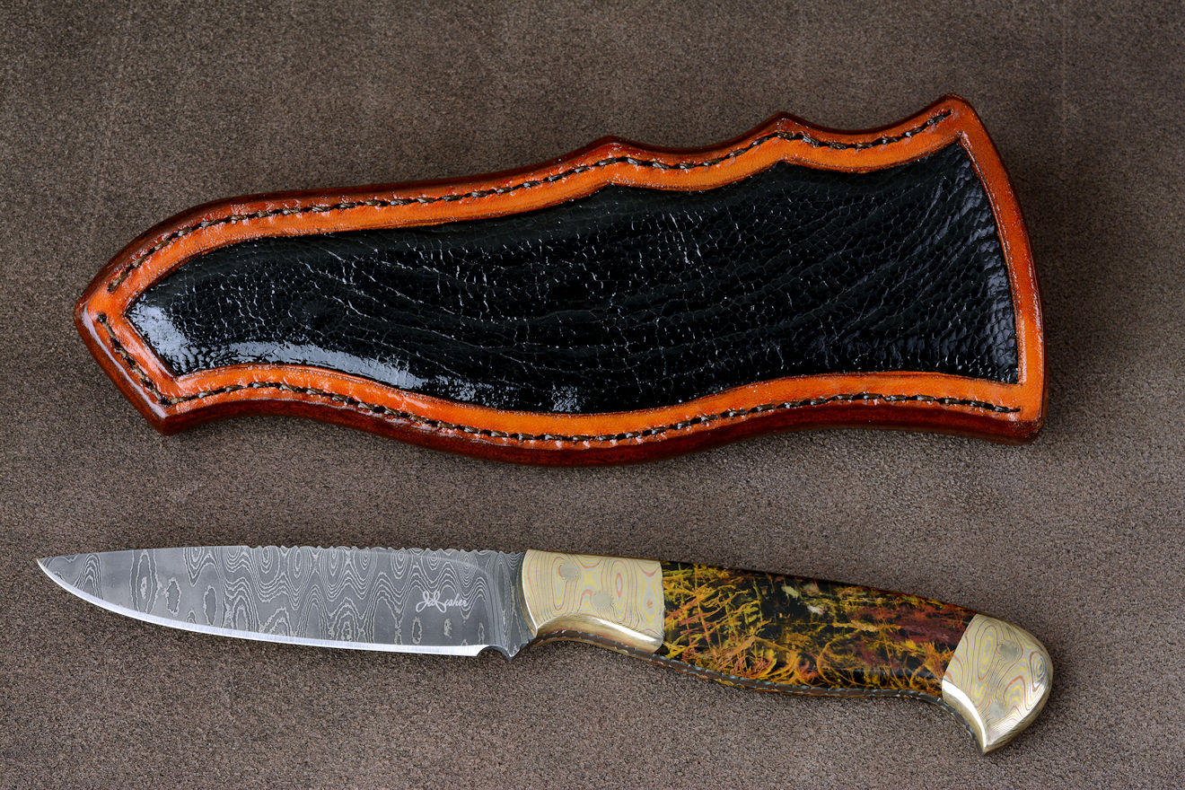 "Tarazed" in stainless steel pattern welded damascus blade, mokume gane diffusion welded and forged bolsters, Pilbara Picasso Jasper gemstone handle, hand-carved leather sheath inlaid with ostrich leg skin