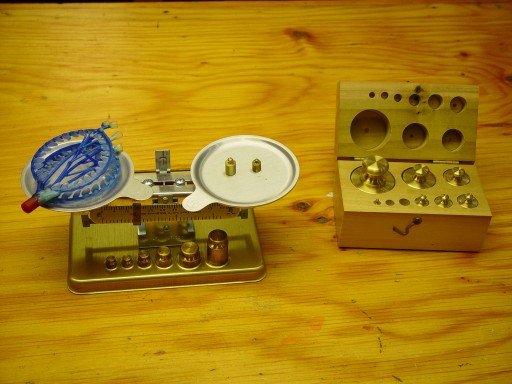 Weighing wax model with beam balance scale