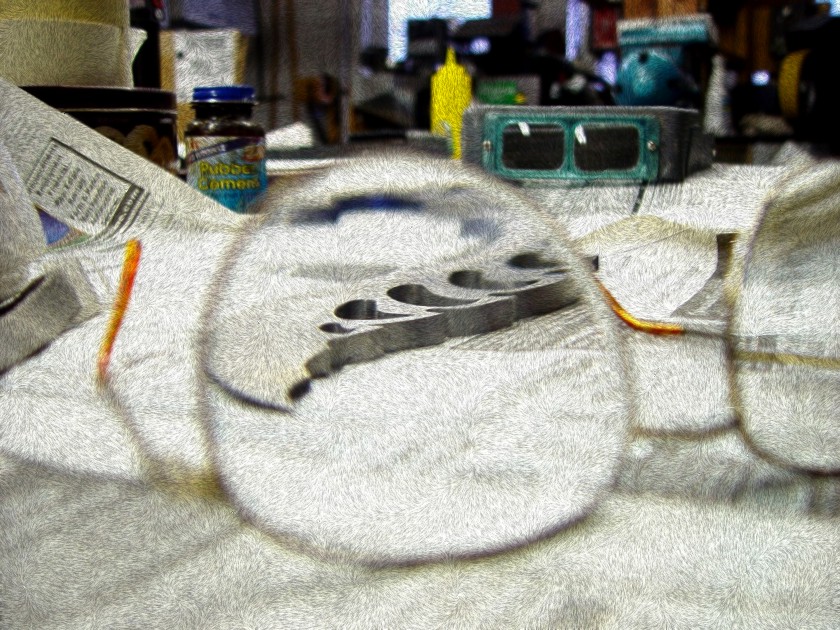 Knife blade through glasses on bench with photographic manipulation