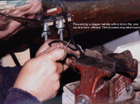 Fileworking a dagger handle. Knife blade is clamped in a vise protected with a leather pad. Photo shows micro file, very small minature file used to make delicate cuts