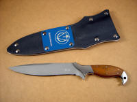 "Kapteyn" professional tactical combat knife, obverse side view; 440C high chromium stainless steel blade, 304 stainless steel bolsters, Lignum Vitae hardwood handle, kydex, aluminum, nickel plated steel sheath with blue lacquered aluminum flashplate